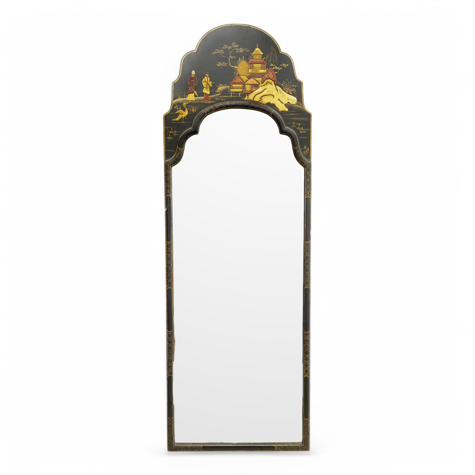 Black lacquered and Chinoiserie wall mirror, the shaped pediment decorated with pagoda in landscape with two figures, plain mirror plate enclosed by moulded surround