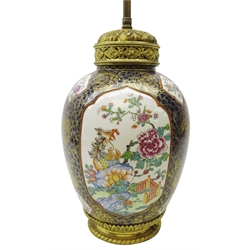  Early 20th century gilt metal mounted French porcelain table lamp, ovoid body enamelled with panels of Oriental style exotic birds in landscapes on a blue & gilt crackle ground, H71cm max   