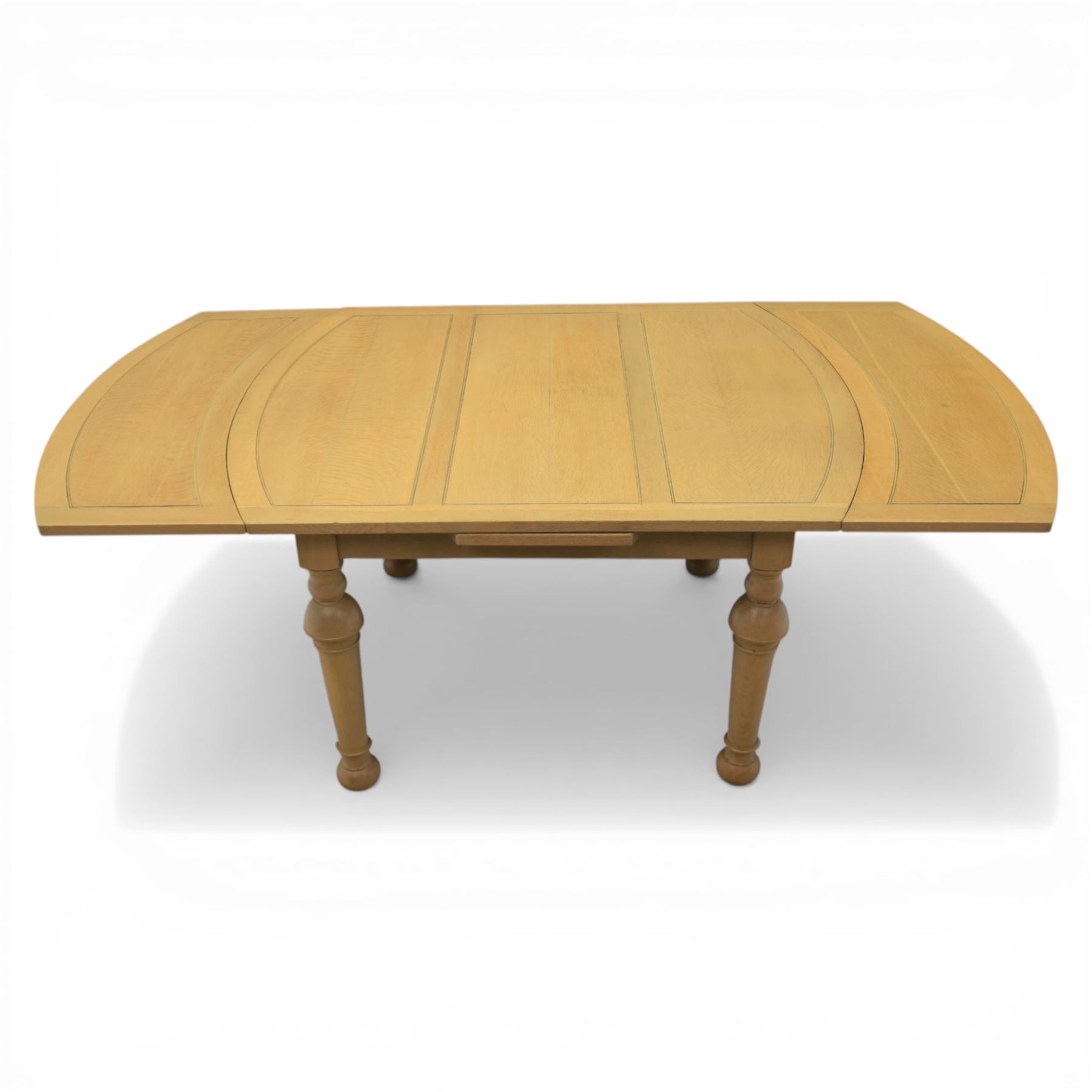 Edwardian light oak extending dining table, oval-ended rectangular top with panelled decoration and double line borders, draw-leaf extension action to 211cm long, on turned supports