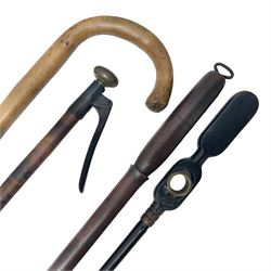 Two late 19th century fruit picker canes, the first example a French ebonised bamboo cane, with pair of fruit scissors to base, the handle stamped Cueille Fruit, the second example with grabbing action, the cap stamped A C Harris, Leicester, together with two other 19th century canes, one with fork and the other with hoe