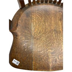 Early 20th century swivel office desk chair, shaped bar back over vertical rails, dished seat, on four splayed supports