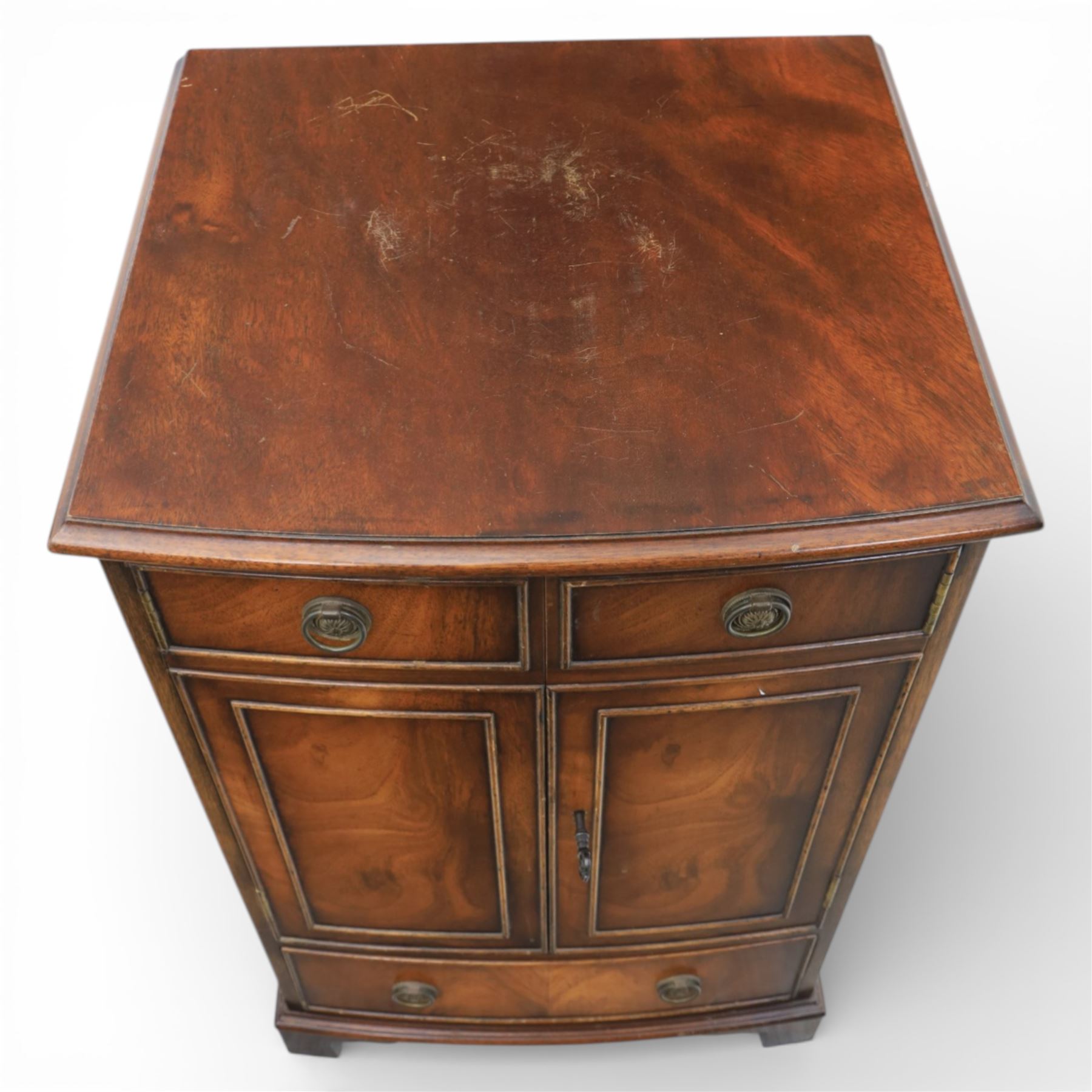 Reprodux - Georgian design pair of mahogany bow-front cabinets, moulded lifting hinged top, above a locking cabinet with drawer below, raised on bracket feet 