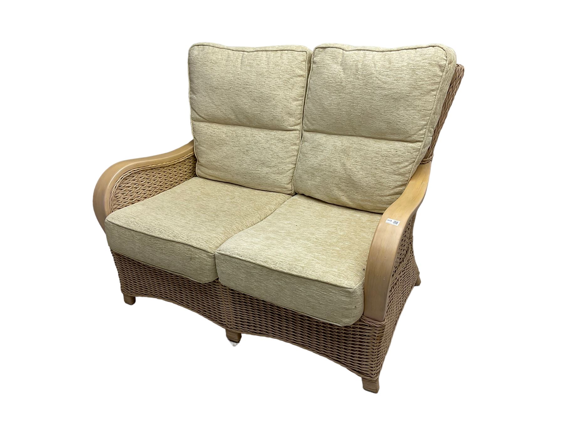 Contemporary rattan conservatory suite - two seat sofa with wicker frame and loose cushions upholstered in textured champagne fabric (W125cm H98cm); pair of matching armchairs (W72cm H98cm); rectangular glass-topped coffee table with rattan frame and undertier (W85cm D60cm H47cm); and matching square side table (W53cm H55cm)