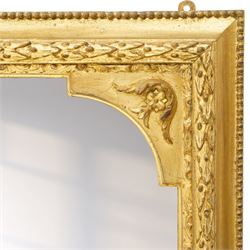 Victorian giltwood and gesso framed overmantel mirror, the scallop shell pediment with trailing acanthus leaves over a foliate moulded slip with beaded outer-edge, of rectangular arced form with floral spandrels, the base with further extending pierced scrolling acanthi decoration