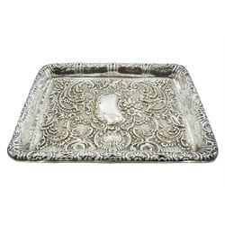 Edwardian silver dressing table tray, of rectangular form with repoussé scrolling foliate decoration and central vacant shaped panel, hallmarked George Nathan & Ridley Hayes, Chester 1902, L26.5cm, approximate weight 7.55 ozt (235 grams)
