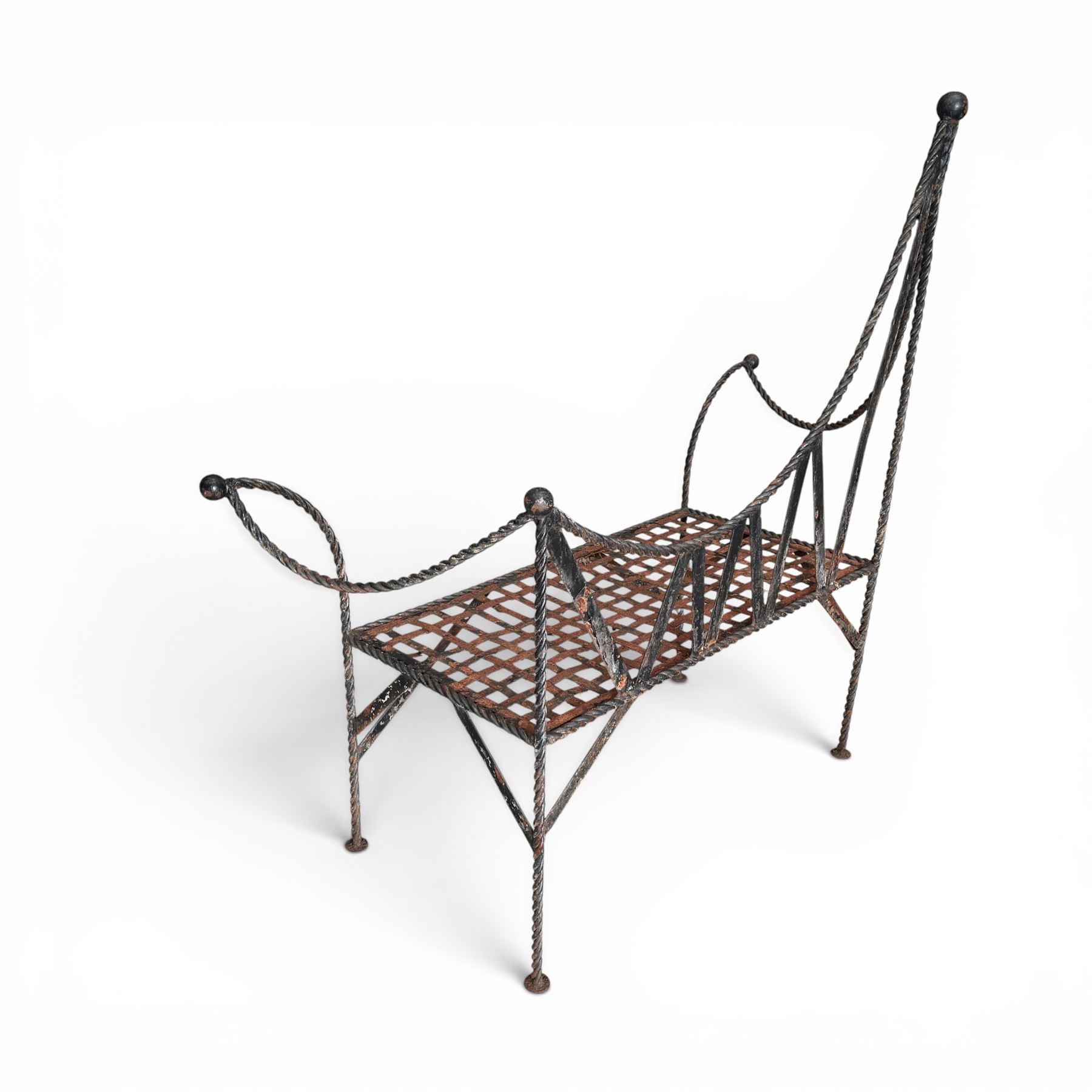 Victorian design wrought iron garden bench, with asymmetrical rope-twist frame, arched back and sides over out-swept arm terminals with ball finials, flanking a lattice seat, in antique black-painted weathered finish