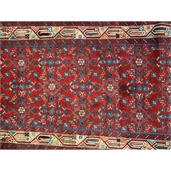 Persian Hamadan red ground runner rug, the field decorated with herati motifs, geometric design border the outer and inner guard, 79cm x 537cm