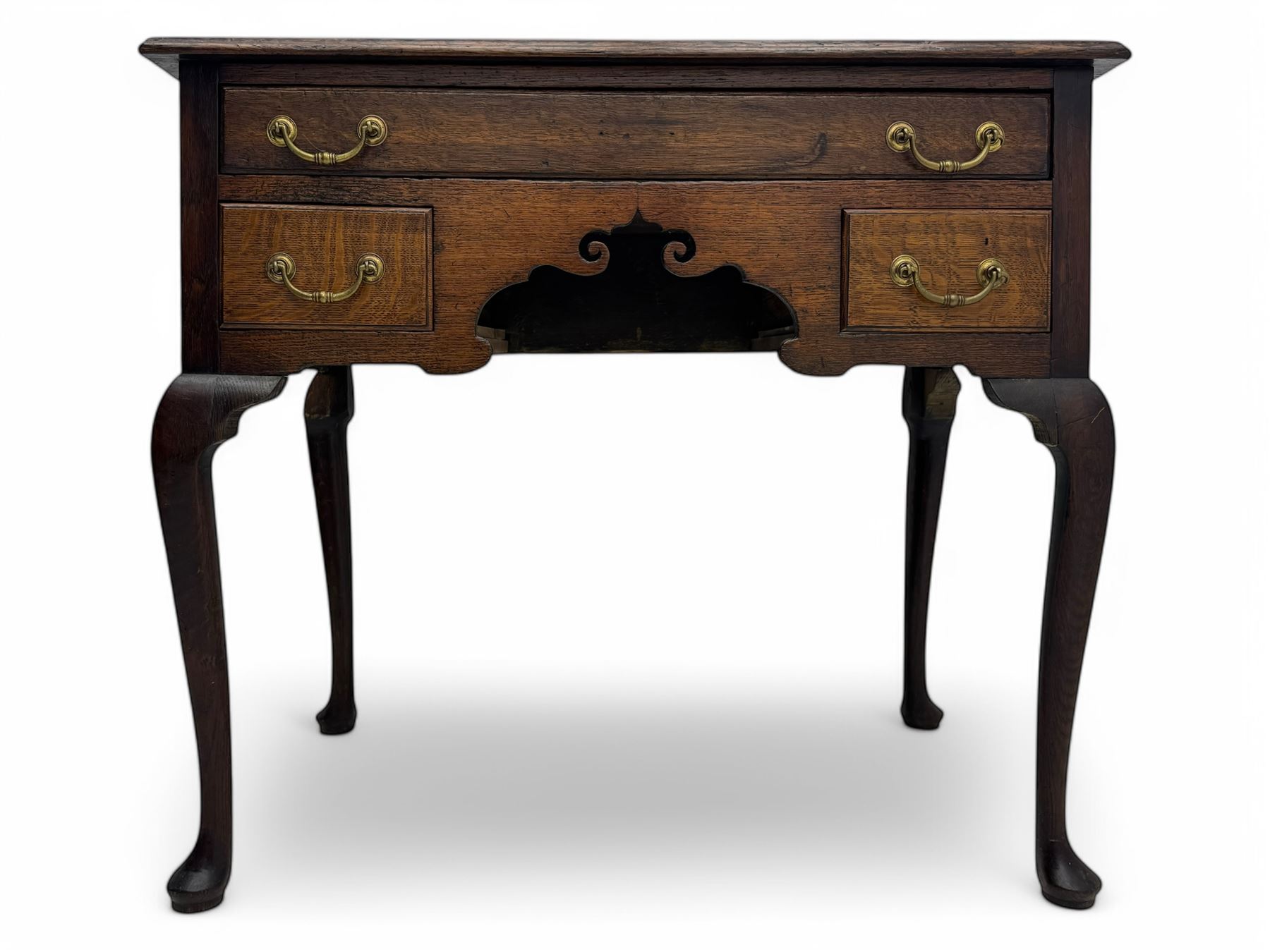 George II oak lowboy, moulded rectangular top over one long and two short drawers fitted with brass drop handles, shaped apron with scrollwork carvings, raised on cabriole supports
