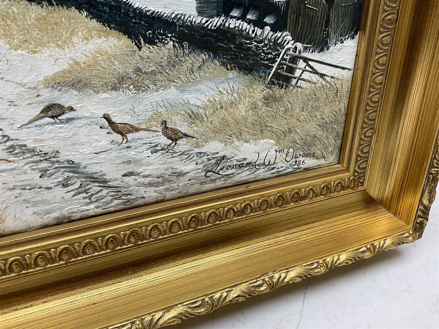 Leonard W Owens (British 20th century): 'Pheasants by a Farm near Hutton-Le-Hole', oil on canvas signed and dated 1986 together with Chris Hammond  (British 20th century): 'Springtime', watercolour signed, titled and dated 1990 verso max 30cm x 45cm (2)