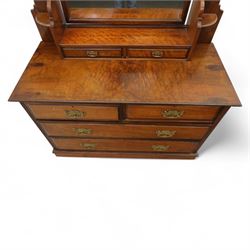 Edwardian walnut dressing chest, rectangular top surmounted by a mirror frame with shaped pediment on swing supports above two short frieze drawers over two short and three long graduated drawers fitted with brass foliate handles, raised on a plinth base