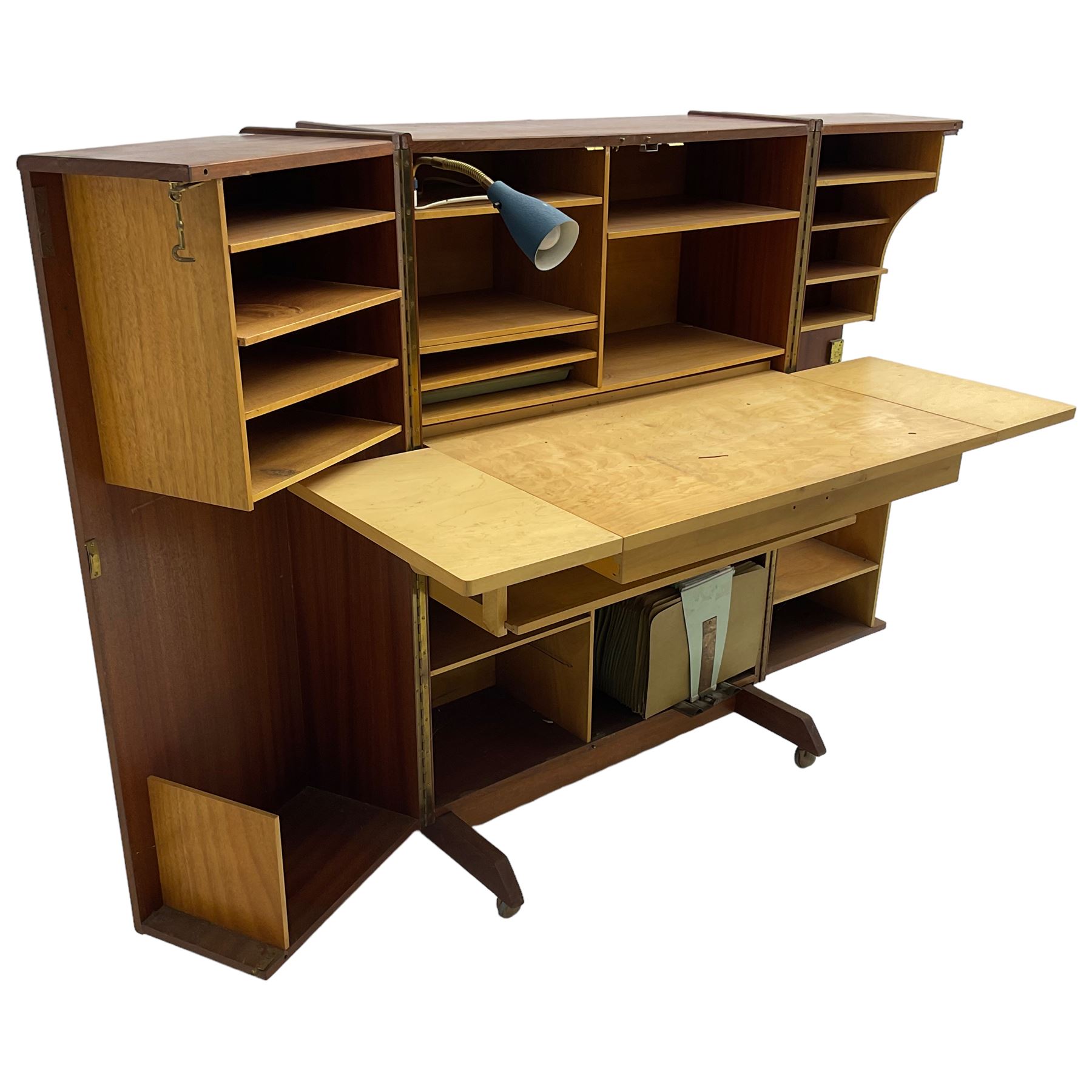 Mummenthaler & Meier - mid-20th century circa. 1960s teak 'Magic Box' folding desk cabinet, the cabinet opens to reveal shelves, writing desk, document holders and lamp, on castors