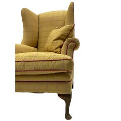 Pair of mid-20th century Georgian design armchairs, high wing backs, upholstered in pale gold fabric