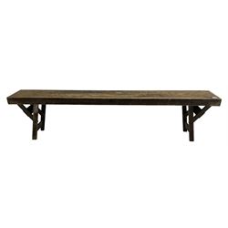 20th century pine folding table, rectangular top on square supports joined by stretchers (244cm x 68cm, H76cm); together with a similar folding bench (181cm x 25cm, H43cm) 