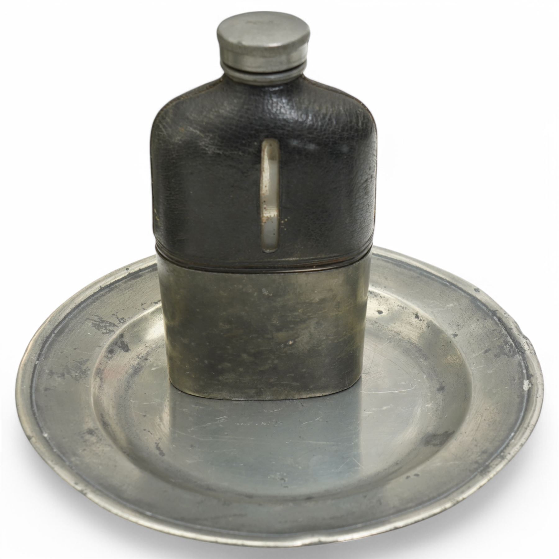 Collection of early 19th century and later British pewter, mostly London label marks, including two large pewter chargers, medicine spoon, flasks, plates and other tableware