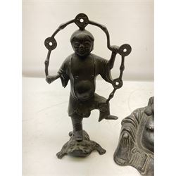 Cast iron figure of Liu Hai, the Chinese God of Wealth modelled standing with one foot upon mythical three-legged chánchú toad and holding a string of Chinese coins, H21cm, together with a cast iron figure of a seated laughing Buddha