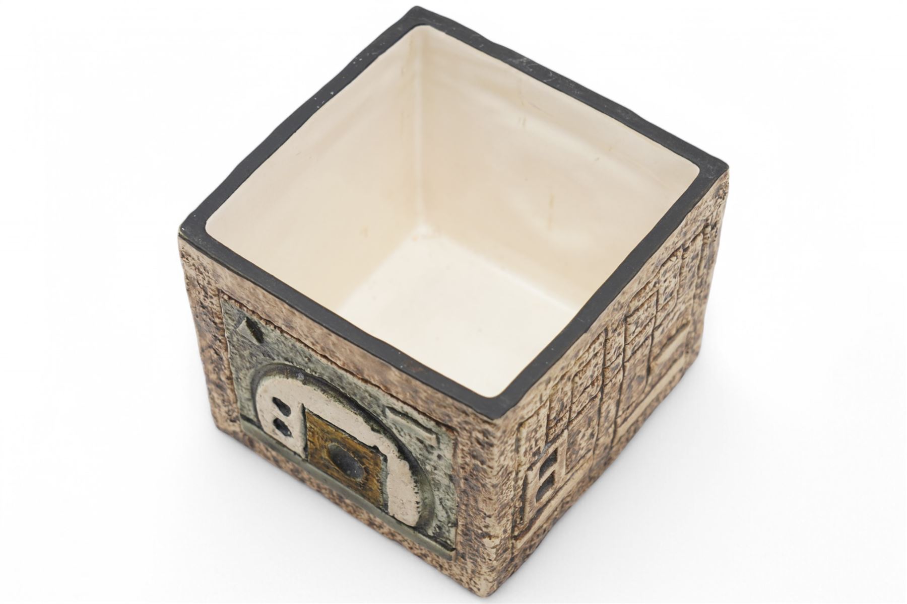 Troika cube vase, with incised geometric decoration in green and cream on a mottled light brown ground, signed to base with initials for artist Shirley Wharf, H8.5cm