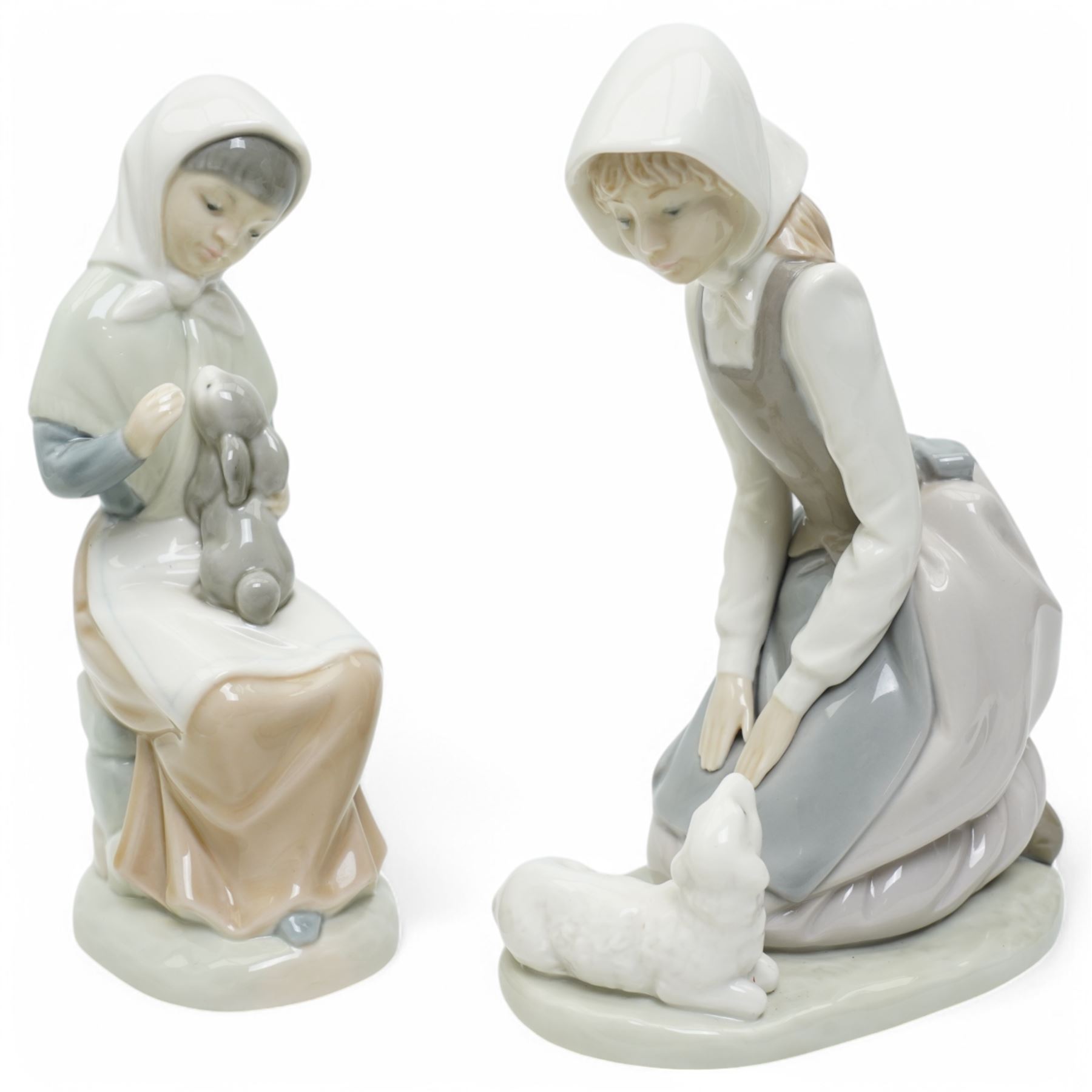 A group of eight Nao figures, together with one Lladro Polar Bear figure, each with printed mark beneath (9)