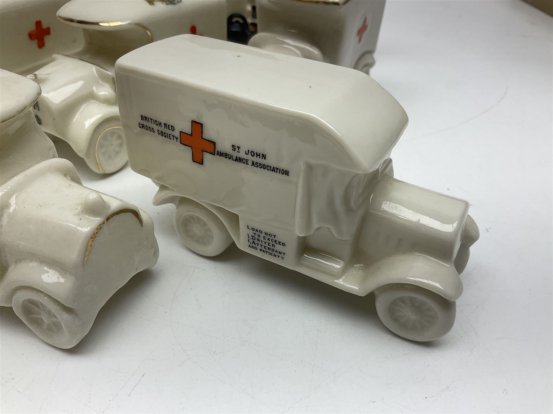 Ten WW1 crested china military models comprising seven field ambulances and three 'Home Fires Burning' fire-surrounds/range; various makers including Willow Art, Arcadian China, Grafton China, Savoy China, Carlton China etc; various crests including Devon, Aldershot, Portsmouth, West Ham, Coventry, Oxford, Hastings, Brighton etc (10)