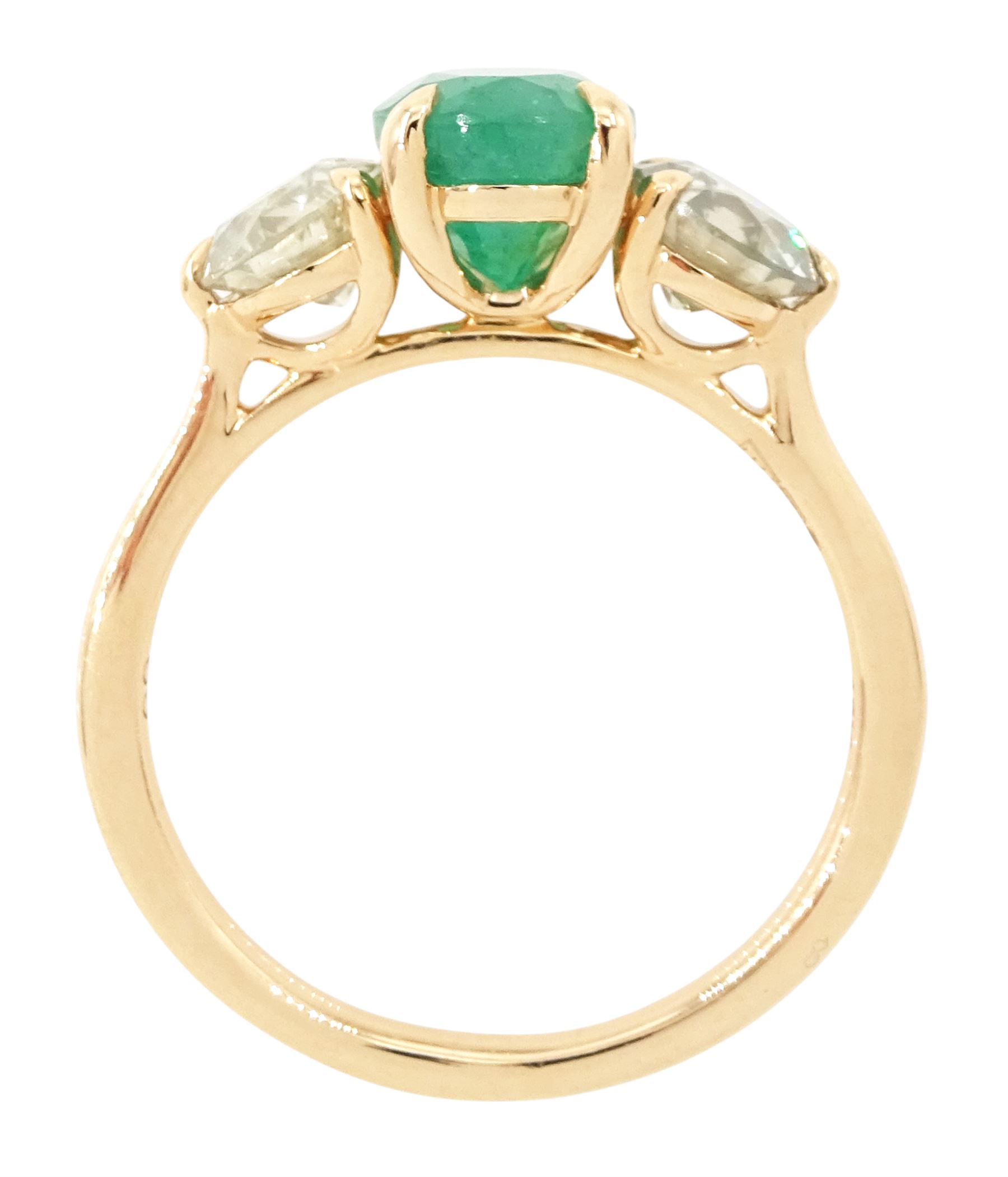 18ct rose gold three stone emerald and diamond ring, single oval cut emerald of approx 1.80 carat, with a round brilliant cut diamond set either side, hallmarked, total diamond weight approx 1.20 carat