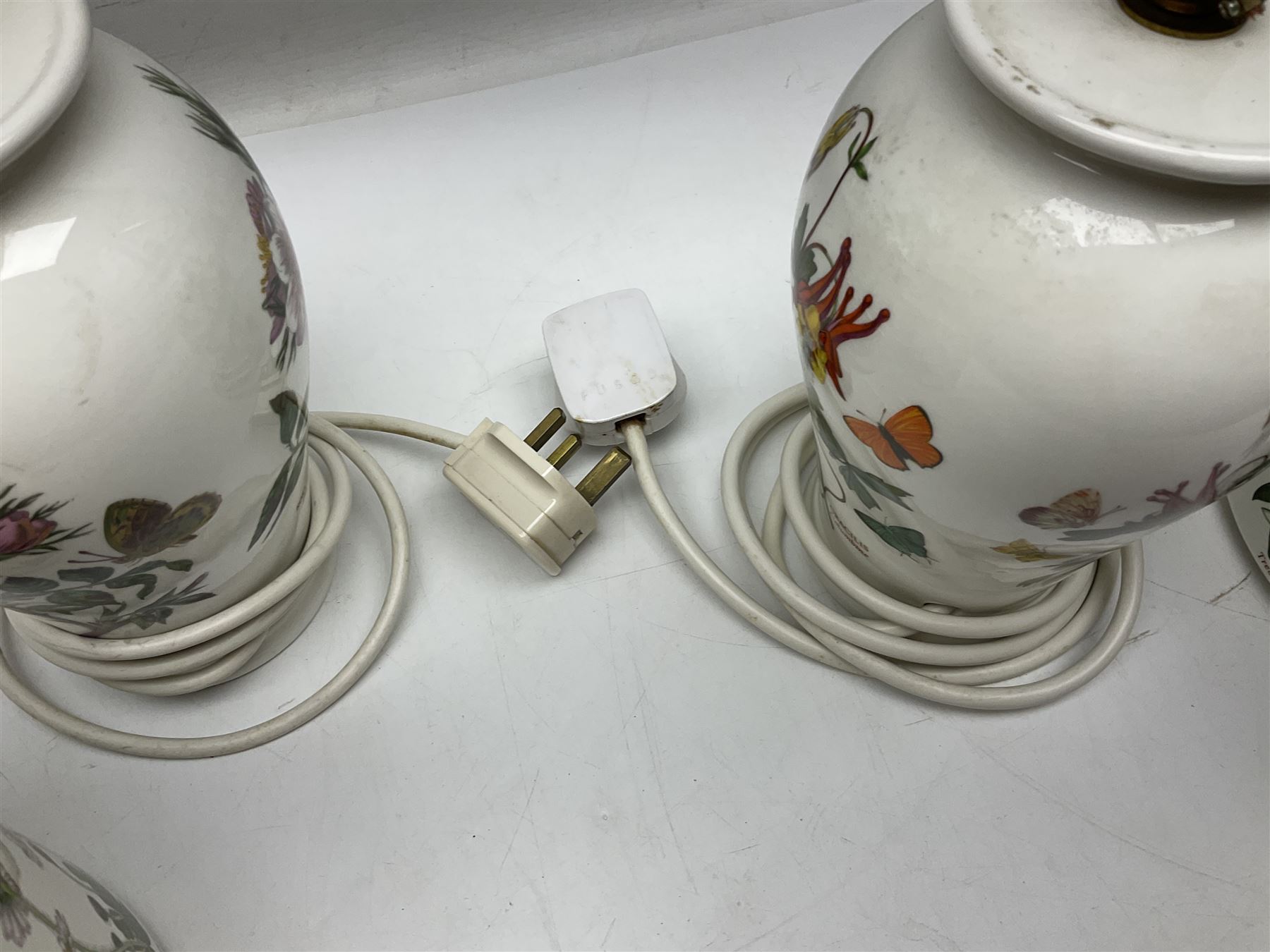 Two Portmeirion Botanic Garden table lamps, together with two Portmeirion Botanic Garden planters