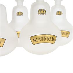 Set of four 20th century Royal Pharmaceutical Society white frosted glass bottles, of bellied form with clear cut glass spire stopper, each body bearing gilt label in Latin: AQ:CINNAM:, AQ:FOENIC:, AQ:HAMAM:, and AQ:ROSACae:, and gilt Royal Pharmaceutical Society crest to neck, H25cm

Provenance: From the collection of the family of Peter Green, a practising pharmacist whose career spanned the mid to late 20th century. During his professional life he managed pharmacies in Yeovil, Somerset, and later Selles Chemist in Filey, North Yorkshire, before purchasing and running his own business, Peter Green Pharmacy, located in the Market Place, Malton. The bottles were displayed as part of the traditional shop fittings in both the Filey and Malton pharmacies and were retained as part of his collection.