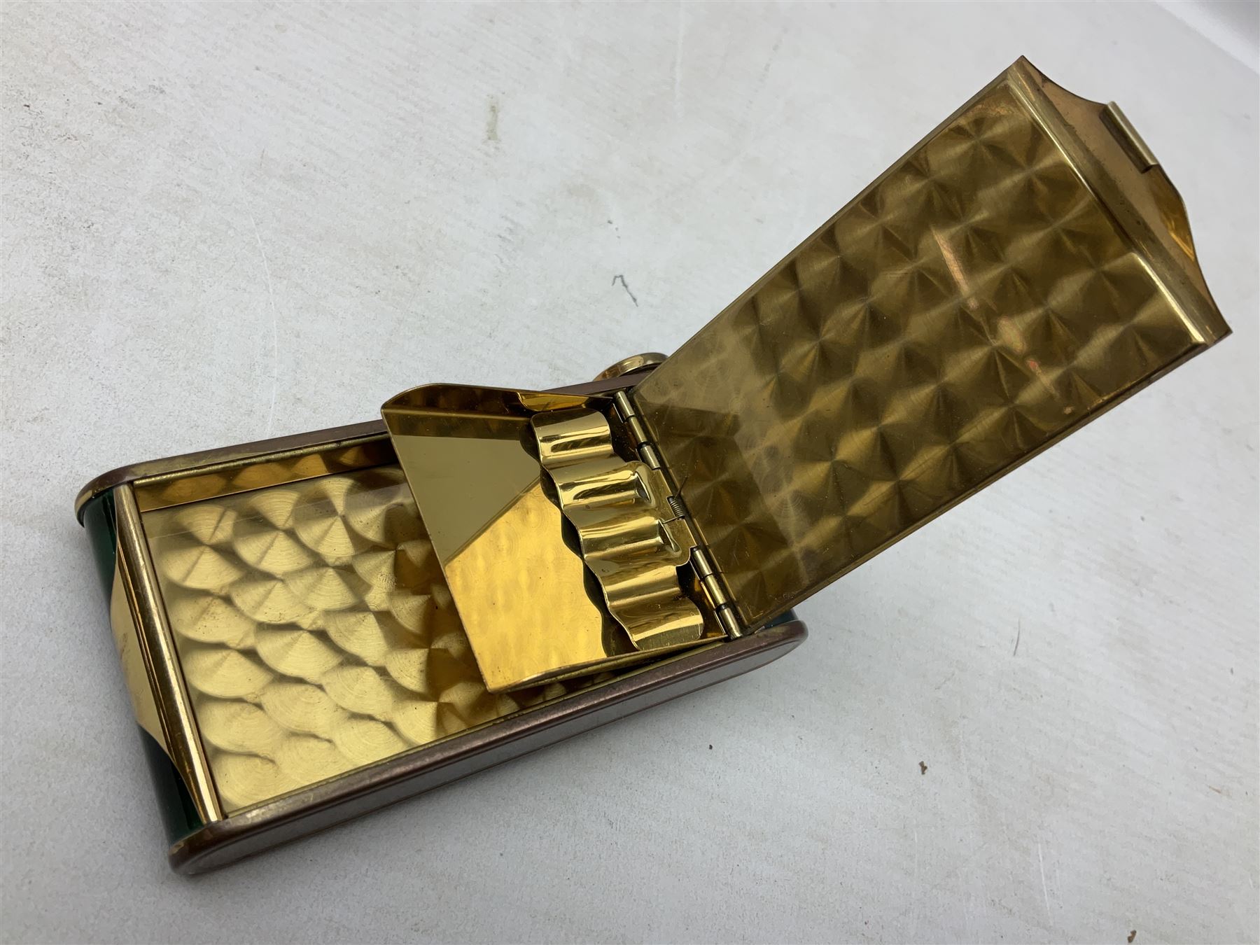 Art Deco camera shaped lady's musical compact and cigarette case, probably German, with green marble effect panels and gilt highlights, with large hinged opening to reveal engine turned brass interior with cigarette or lipstick holders, and the other side with musical mechanism and flip action powder compartment with mirror, L10cm