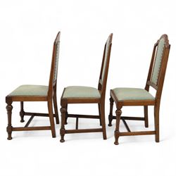 Victorian mahogany extending dining table, rectangular top with chamfered corners above a plain frieze raised on turned reeded legs with castors and two additional leaves, 197cm fully extended, and a set of six early 20th century oak upholstered chairs with drop-in seats, arched panelled back splat and close studded border on turned front legs joined by stretchers, 47x41x109cm 