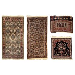 Persian-style wool rug, cream field with floral and geometric motifs, wide floral border (74cm x 142cm); Persian wool rug, beige field with dense floral patterns, narrow floral border (70cm x 144cm); Tribal wool rug, red and navy with diamond motifs (96cm x 60cm); Persian pictorial wool rug, black field with vase, birds, and floral border (70cm x 73cm)
