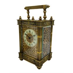 French - Matching pair of Edwardian 8-day timepiece carriage clocks with bevelled rectangular glass panels and overlaid friezes in gilt repousse work with fretted dial masks,  circular enamel chapter ring with Arabic numerals and steel spade hands, both clocks with single train movements, one movement with a jewelled cylinder platform escapement and the other with a jewelled and silvered lever platform escapement.
No Keys.