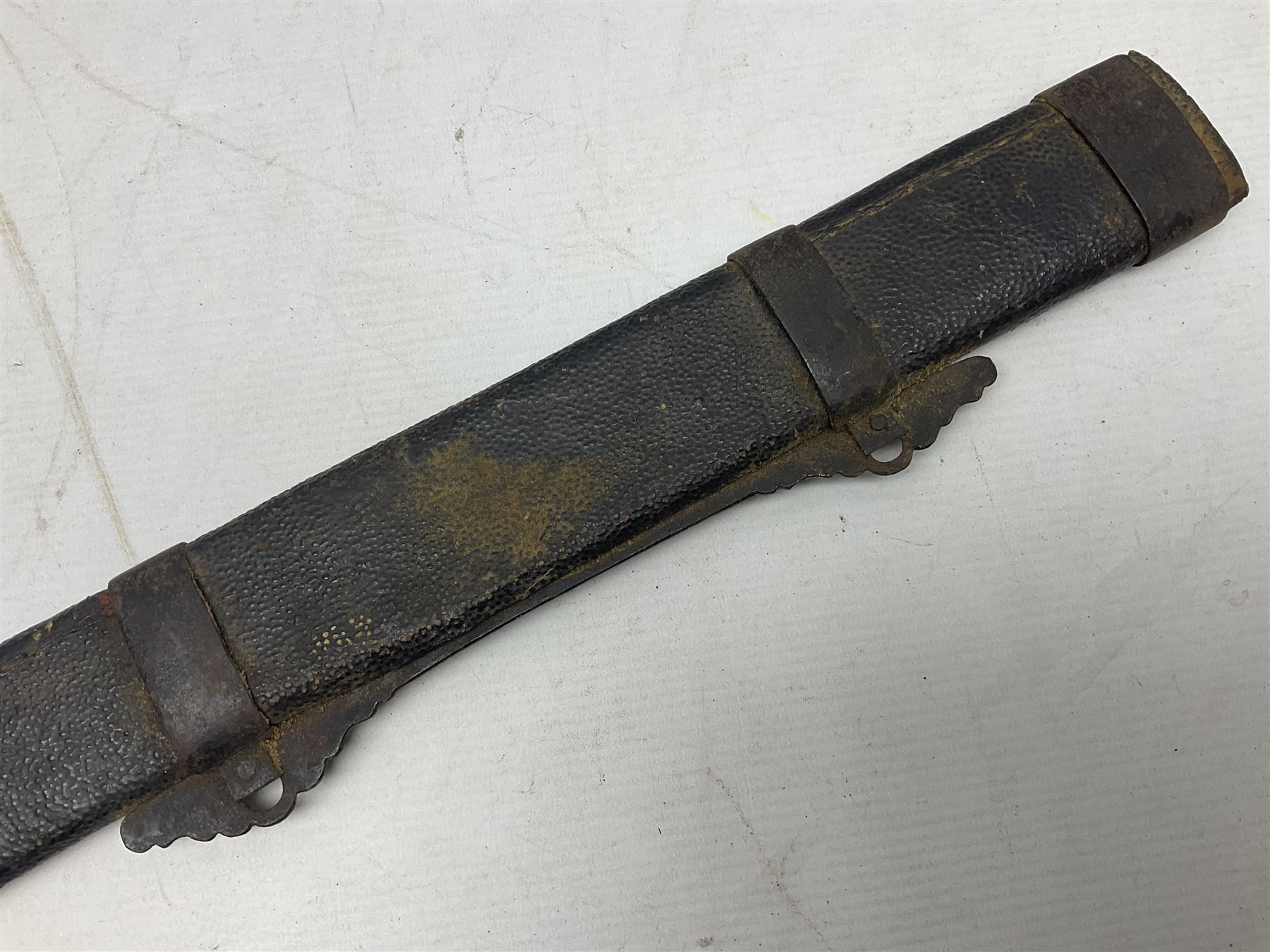 Chinese Boxer Rebellion Period Sword, 69.5cm heavy curved single edge blade with single narrow fuller, plain iron dished circular guard, iron pommel and ferrule with plaited cord bound grip; in skin covered wooden scabbard with iron chape and long suspension mount L95cm overall