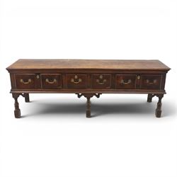 17th century 8’ oak dresser base with moulded front, rectangular top, above four drawers, raised on turned and block support 