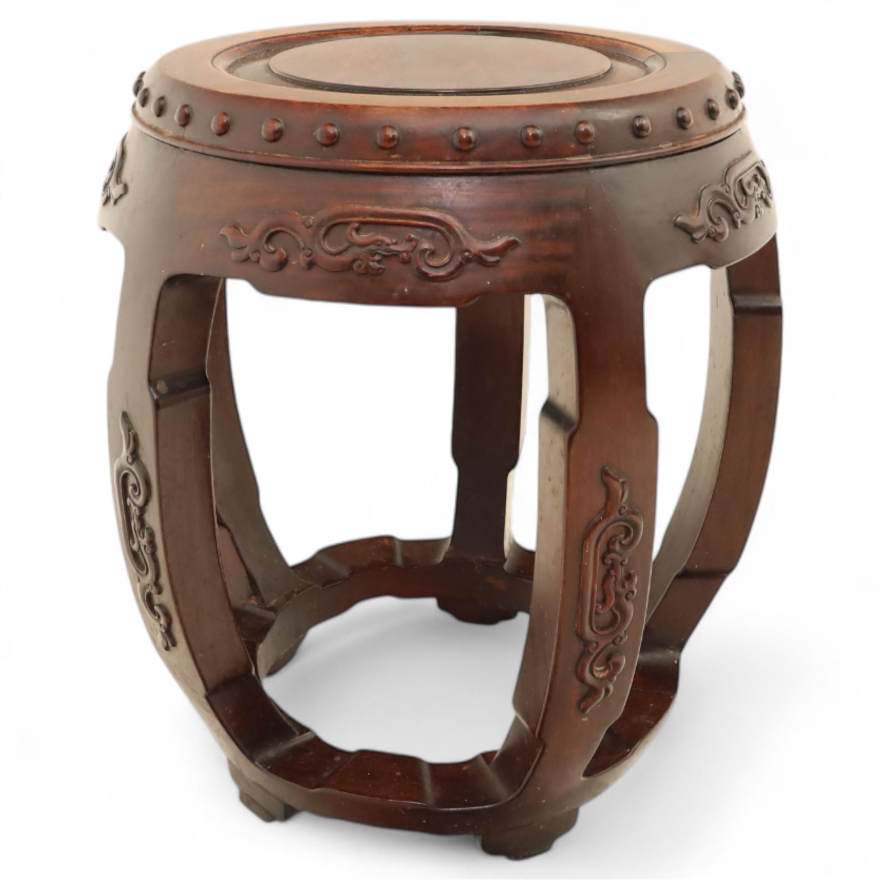 Pair of early 20th century Oriental hardwood barrel seats, of drum form with shaped apron and pierced panels, carved with stylised scrollwork and studded detail to the top