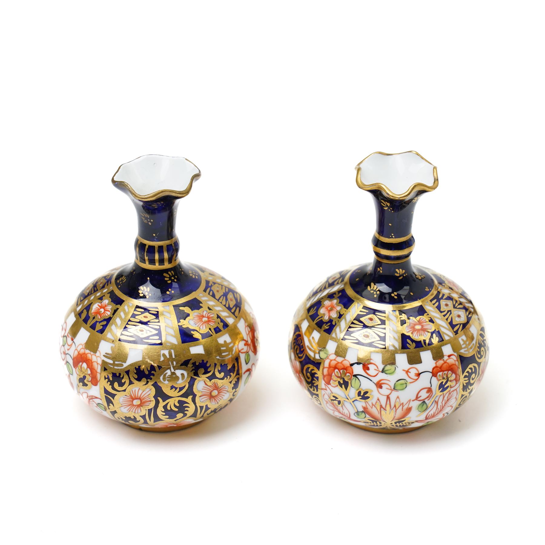 Mixed Royal Crown Derby Imari 6299 pattern wares, including a pair of vases, H8cm; covered twin handled urn, H14cm; slender vase, H19cm, and a pattern 2451 plate, D23cm (5)