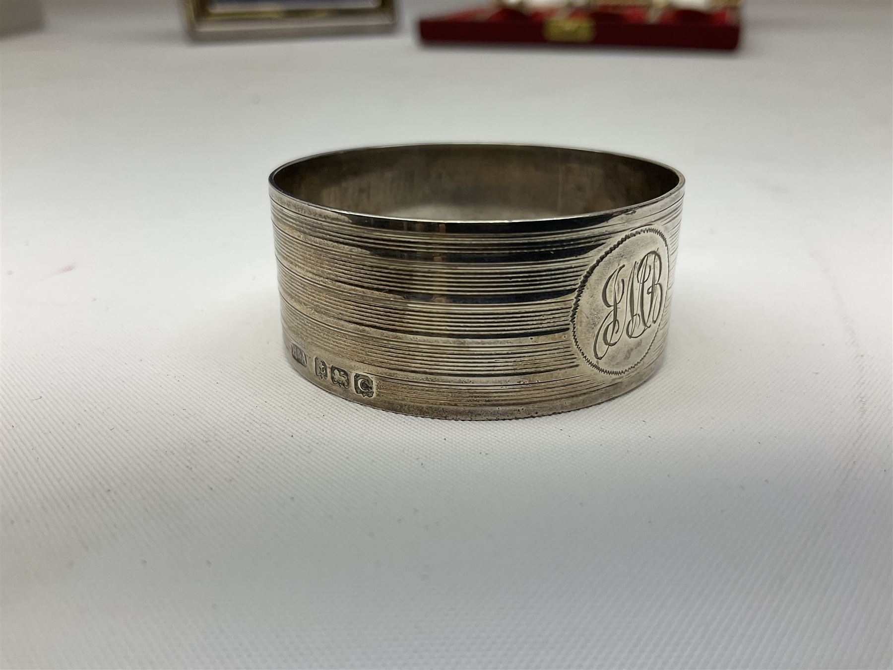 Set of six 1960's silver coffee spoons, hallmarked Sheffield, contained within a fitted case with interior inscribed Harrods, together with a silver napkin ring, hallmarked Birmingham, and a silver plated photograph frame, approximate silver weight 68.4 grams