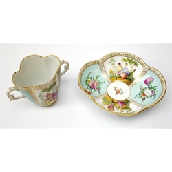 A Helena Wolfsohn Dresden porcelain quatrefoil twin handled chocolate cup and stand, painted with panels of courting figures and floral sprays upon a light blue ground, each with painted mark beneath, saucer L14.5cm, cup H8cm. 