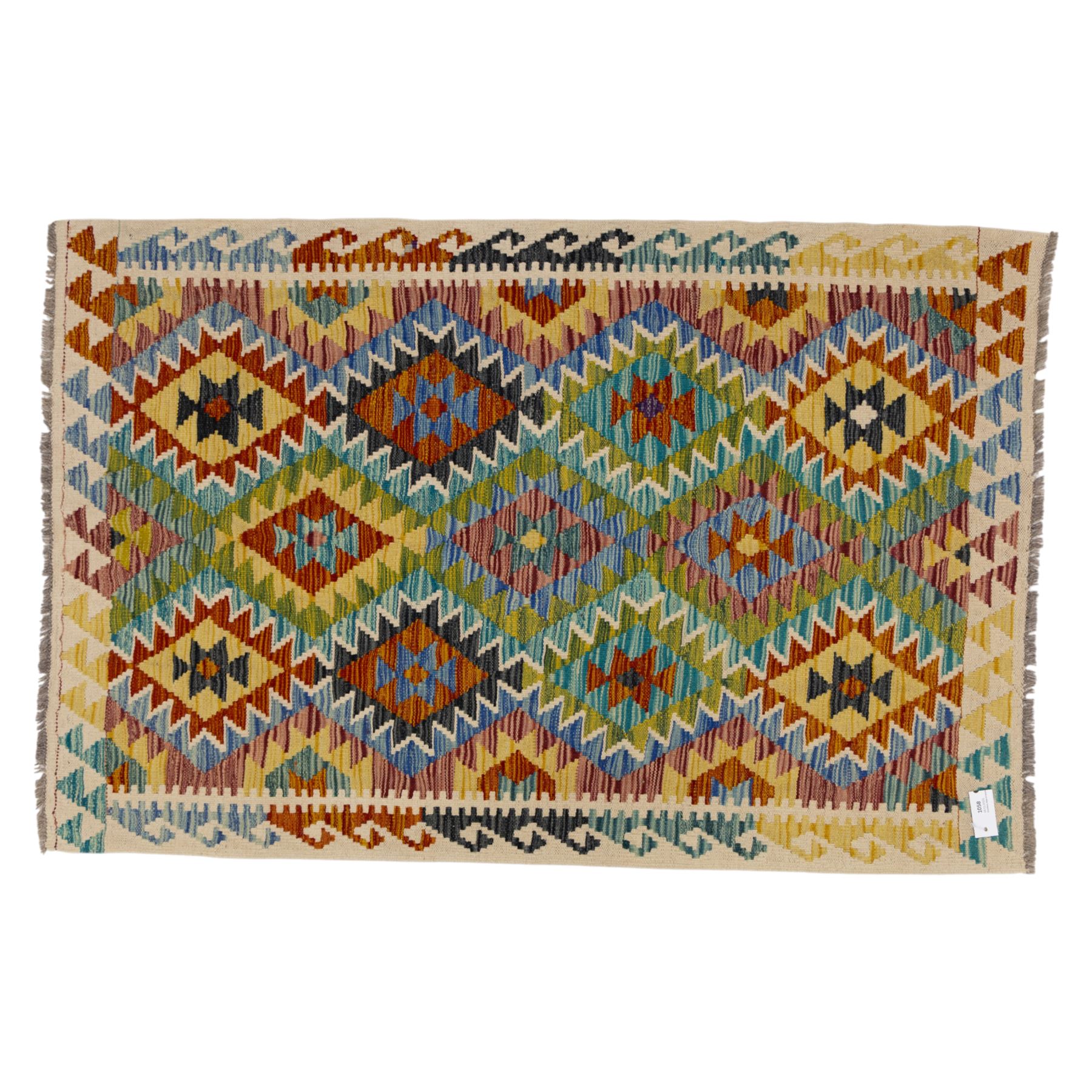 Chobi flatweave kilim with a repeating stepped diamond medallion design in live green, rust, teal, purple, and ivory, framed by chevron and geometric borders