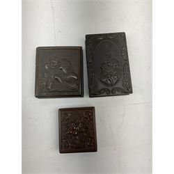 Three Victorian thermoplastic Union cases, the largest decorated in relief with mother, child, puppy and cat, the second with two young children, and the third with a spray of fruits, two cased containing daguerreotype/ambrotype portraits, largest H11.5cm when closed W7.5cm