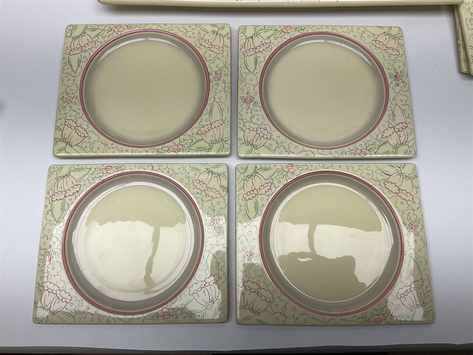 Clarice Cliff Biarritz part dinner set, circa 1930, for Royal Staffordshire, of rectangular form, decorated with bluebells, to include one serving plate, six dinner plates, three side plates, etc, printed mark beneath with reg no 784849 (17)