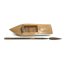 Battery powered model speedboat with blue and white painted wooden hull, simulated planked deck, two rows of seating with fitted ship's wheel and windscreen L92cm together with a native style ceremonial spear (2)