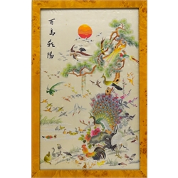 Chinese Republic period silk panel 'A Hundred Birds' decorated with satin stitch embroidery, depicting peacock, hen, cockerel, crane and further birds perched amongst a pine tree in a river landscape, the sun setting in the distance, H55cm x W33cm   