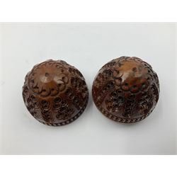 Three 19th century coquilla nut pomanders or flea catchers, two of egg shaped form and the third of barrel from with carved and pierced decoration and screw threaded join, largest H8cm