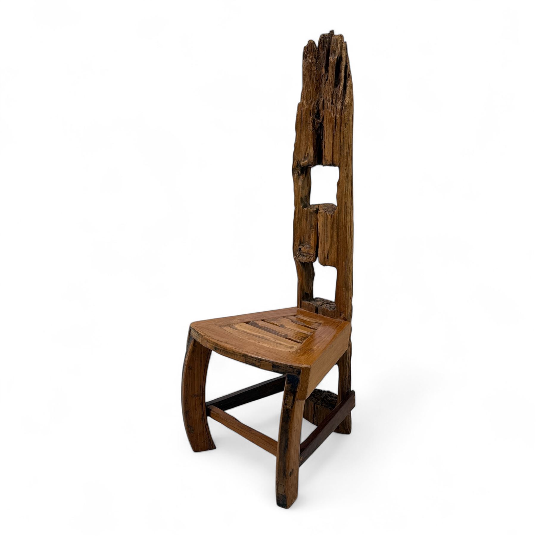 20th century driftwood sculptural hall chair, solid triangular seat over shaped apron, high ladder back formed from weathered and irregular timber, raised on curved legs united by H-stretcher