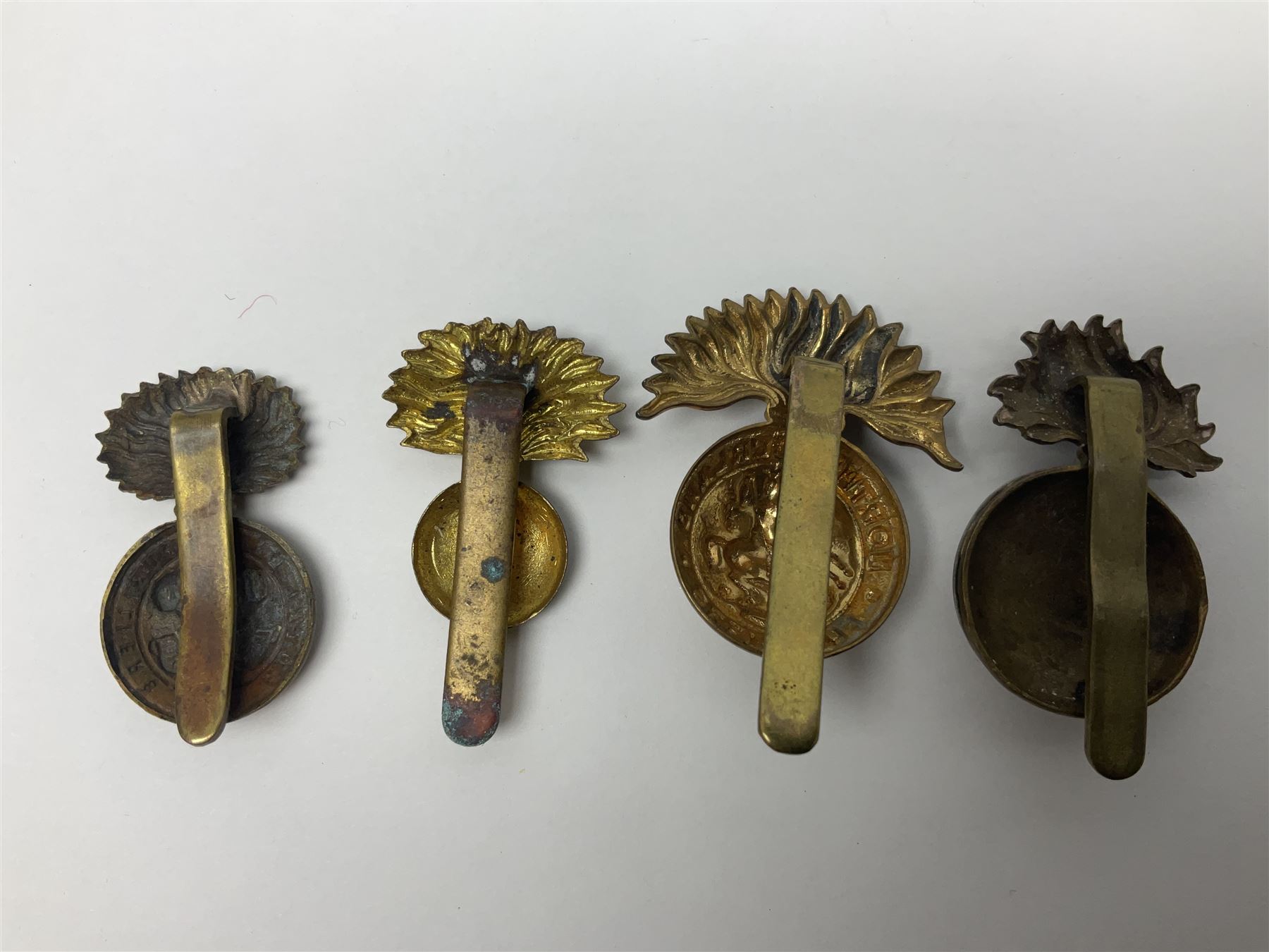 Nineteen Yeomanry metal cap badges including Derbyshire, Northamptonshire, Essex, Glamorgan, Staffordshire, City of London, Surrey, Shropshire, Hertfordshire etc; together with eleven Fusiliers badges including Lancashire, Royal Welch, Northumberland etc (30)