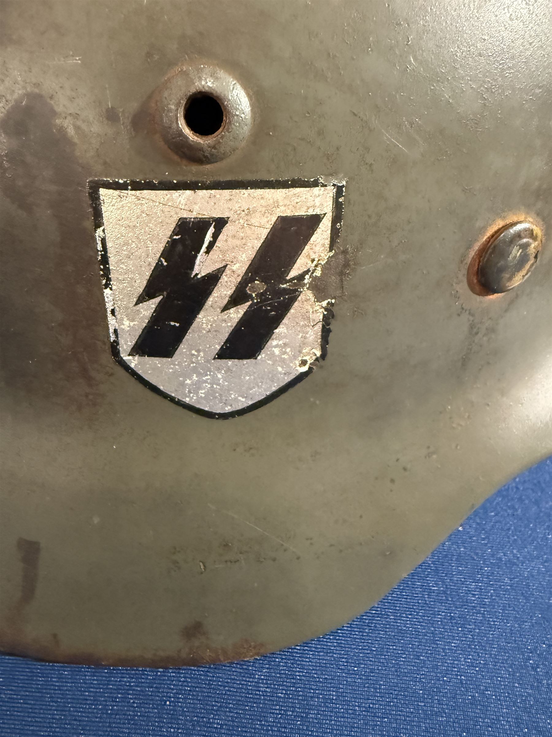 German Third Reich Waffen-SS M35 double decal helmet, the left inner brim stamped SF64, the back inner brim stamped 3866, with leather eight tongue liner and chinstrap