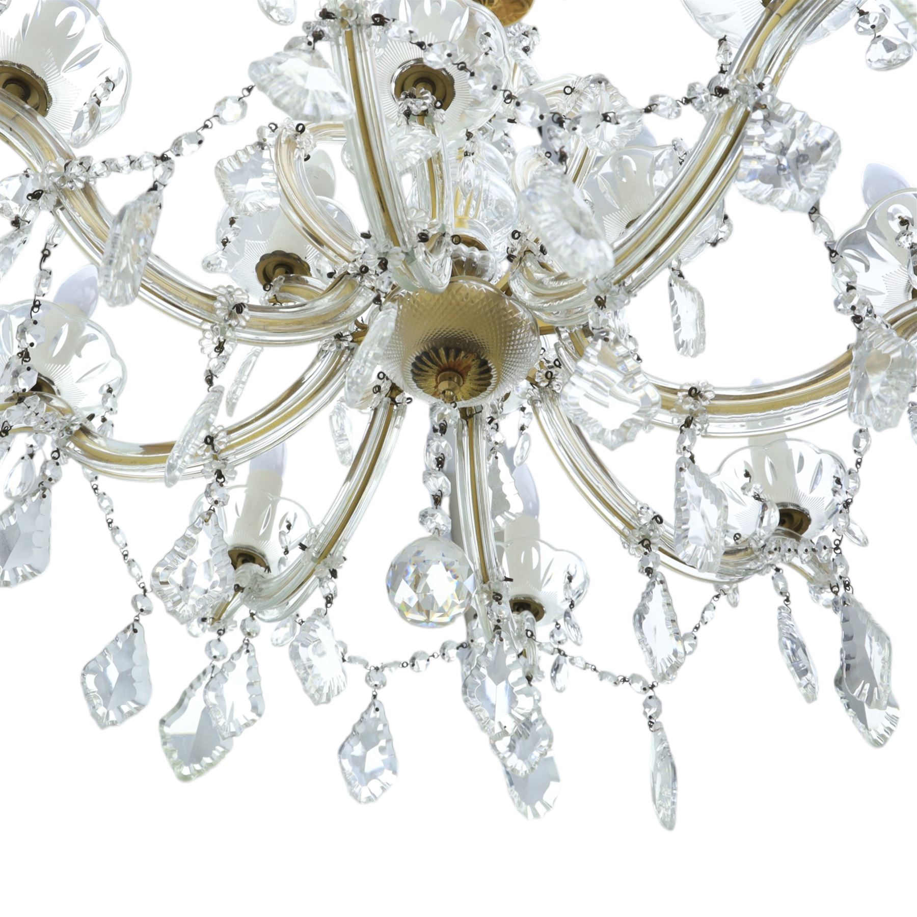 20th century Maria Theresa style twelve branch chandelier, gilt metal frame with scrolling arms clad in moulded glass, the central baluster stem issuing twelve candle sconces with glass drip pans, hung with faceted pendants and swags of cut glass beads 