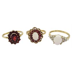 Three 9ct gold rings including garnet cluster, garnet and opal cluster and opal, all hallmarked