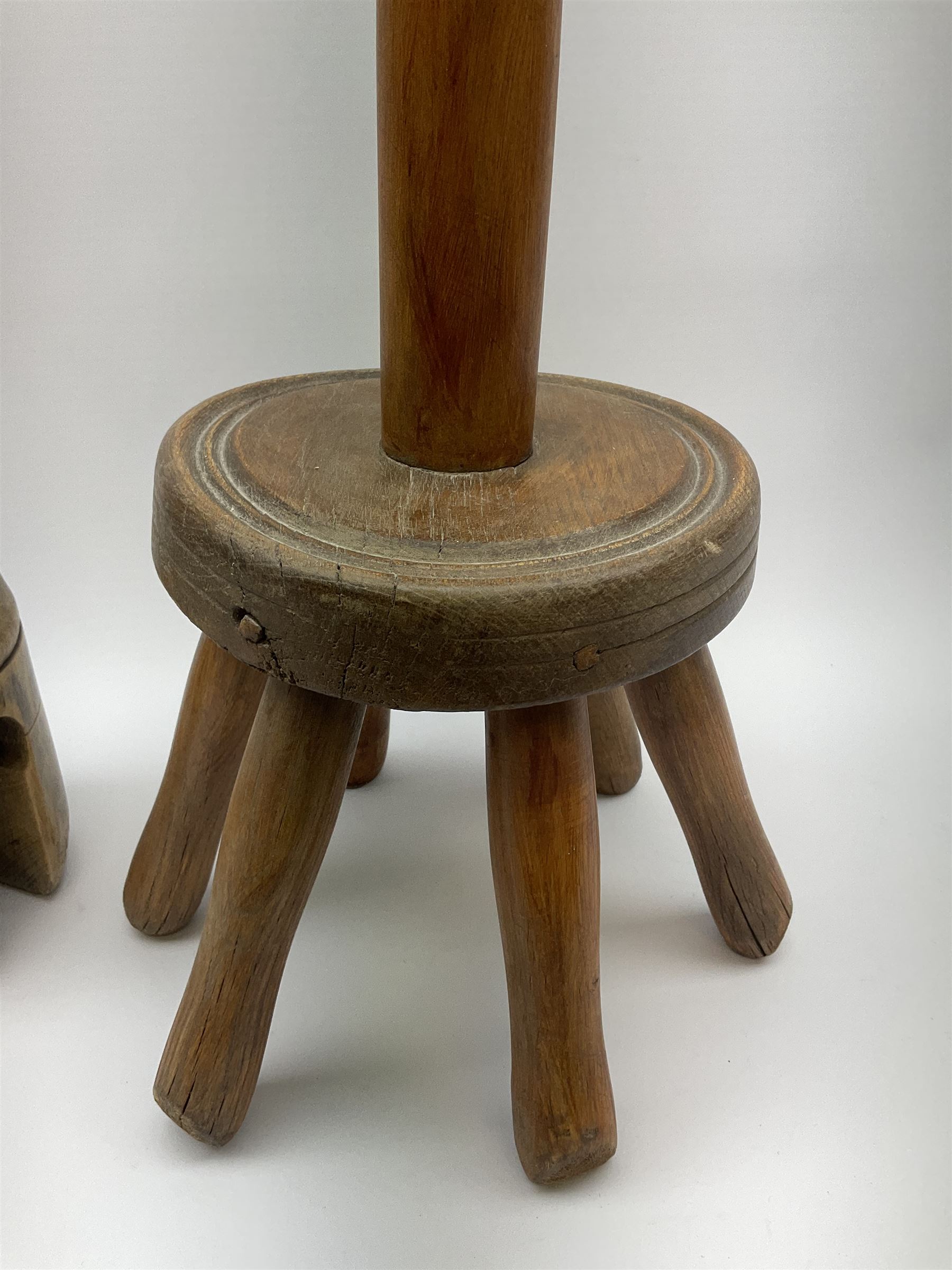 A Victorian dolly peg, together with a further example, both