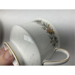 Royal Albert Paragon tea and dinner service for twelve decorated in the Belinda pattern, comprising fourteen saucers, twelve teacups, thirteen side plates, teapot, sauce boat and stand, salt and pepper shakers, two jugs, sucrier, twelve dinner plates, twelve smaller plates, two lidded tureens, twelve bowls, twelve smaller bowls, cake plate, oval plate and oval dish (100)