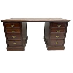 Edwardian mahogany twin pedestal desk, rectangular top with triple inset maroon leather writing surface, fitted with eight graduating drawers flanked by reeded uprights, on skirted bases