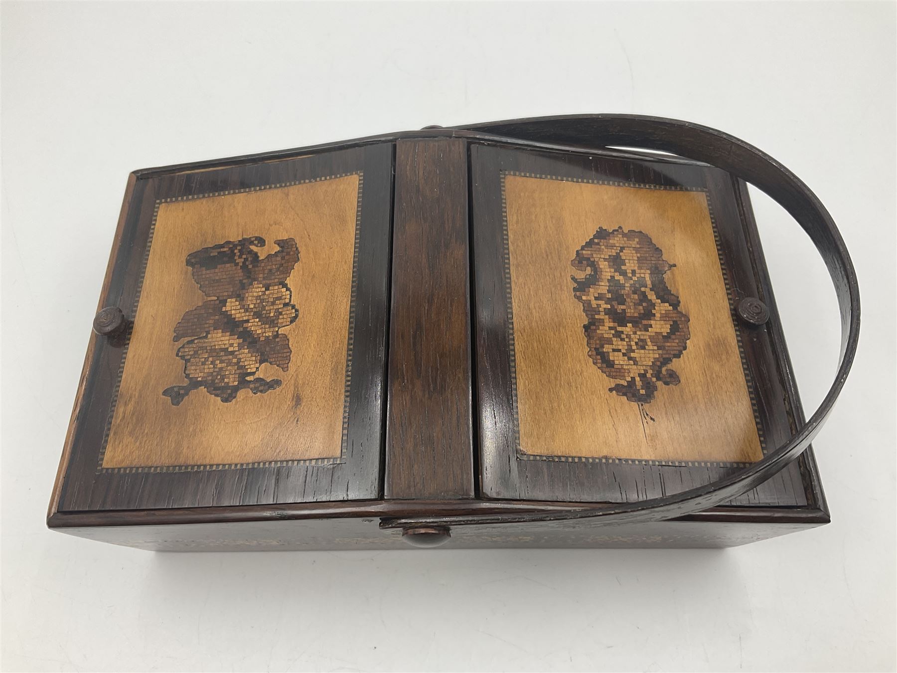 19th century rosewood Tunbridge Ware basket, of rectangular form with curved bentwood handle, and twin hinged sloping covers, lifting to reveal paper lined interiors, not including handle H5.5cm D10.5cm L18cm